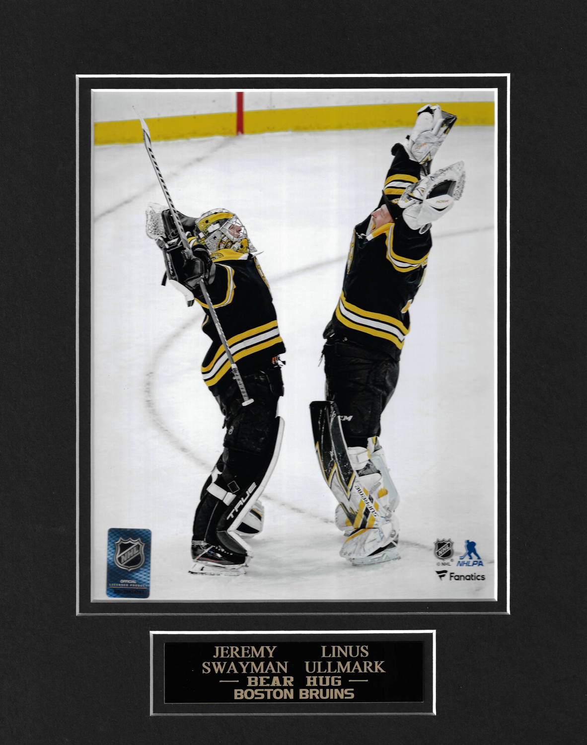 Jeremy Swayman and Linus Ullmark of the Boston Bruins hug after